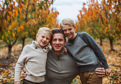 We offer compassionate care to families Dr. Minert smiling with his two sons