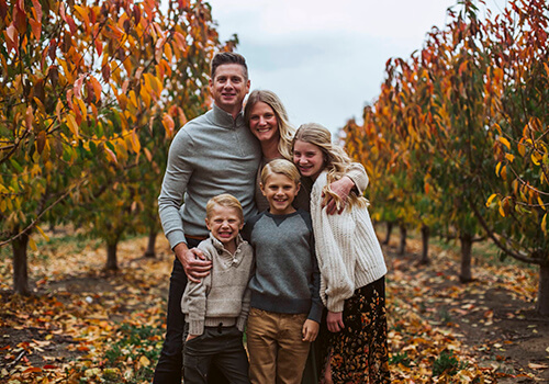 We offer ethical and comprehensive dentistry in Mountain Home, ID Dr. Minert in casual clothes with his family